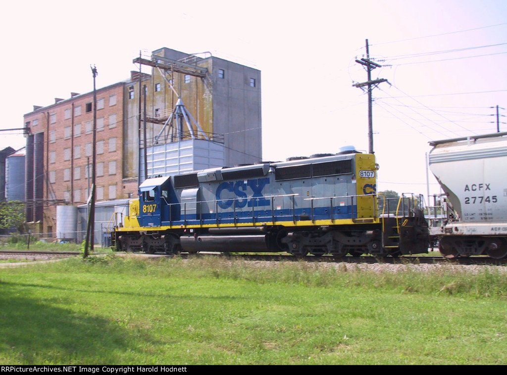 CSX 8107 leads a short train thru town